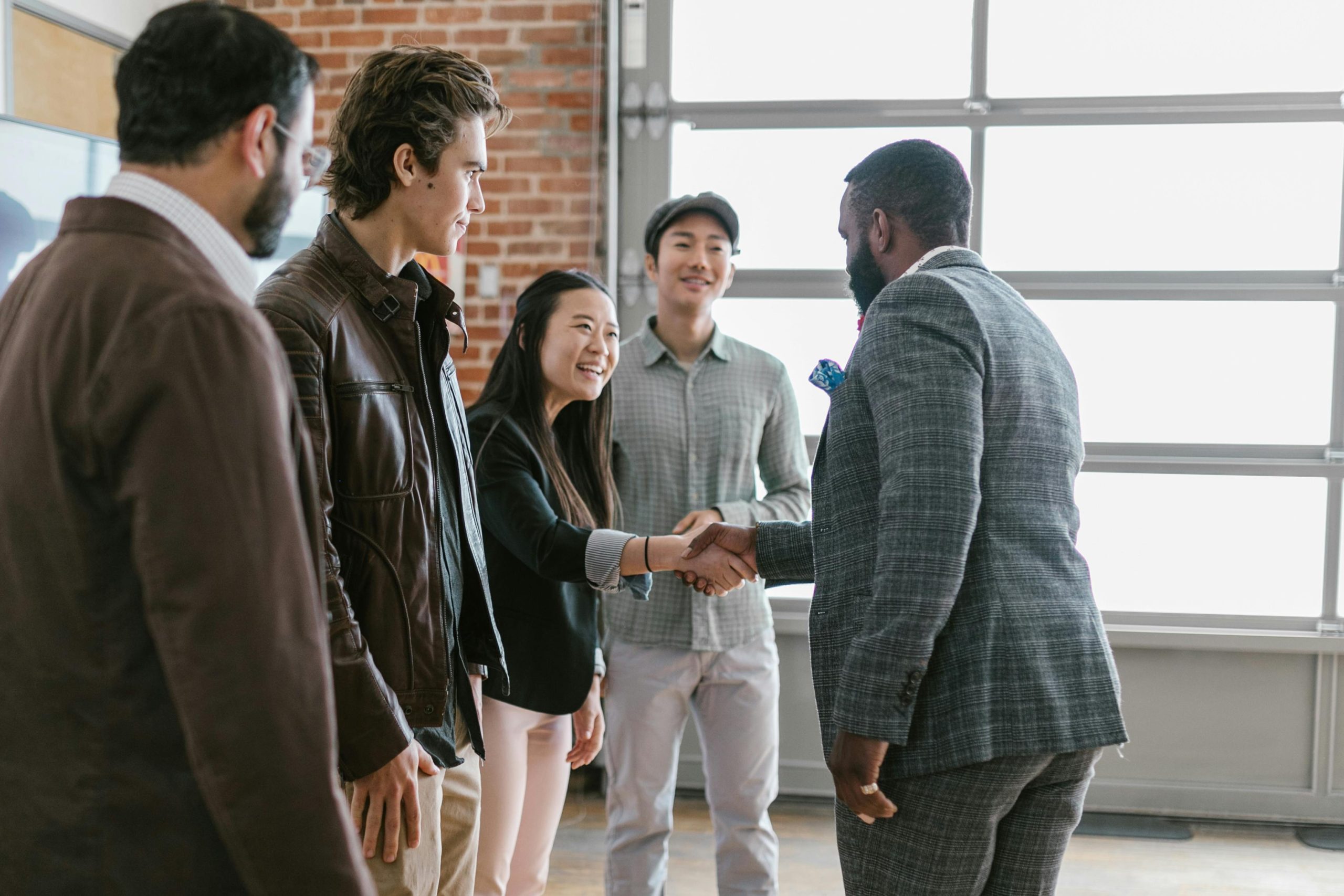 Businessman shaking hands with team, representing trusted financial partnerships and wealth planning solutions